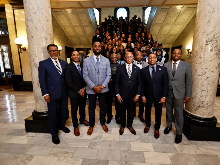 Mississippi legislators join President Marcus L. Thompson, Ph.D., head coach T. C. Taylor, director of bands Roderick Little, Ph.D. for a group photo with JSU athletes.